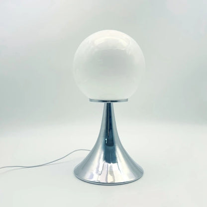 A white glass globe table lamp with a chrome base set against a minimal white background.