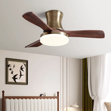 Ceiling fan with wooden blades and a light fixture in a room with a bed and wall art.