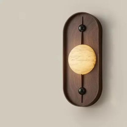 Close-up view of a wooden wall sconce with glowing marble LED globe.