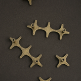 Bronze mechanical components on a dark brown background