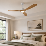 Ceiling fan in a bedroom with a bed, lamp, and wall art.