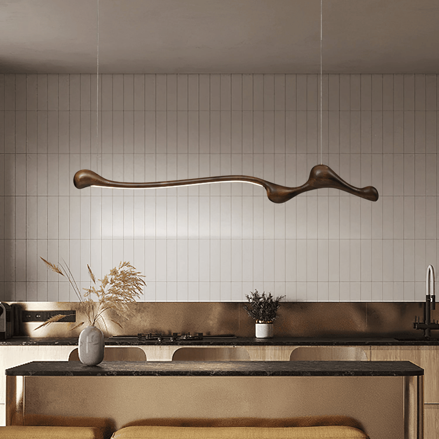 Modern kitchen with a long, curved pendant light fixture.
