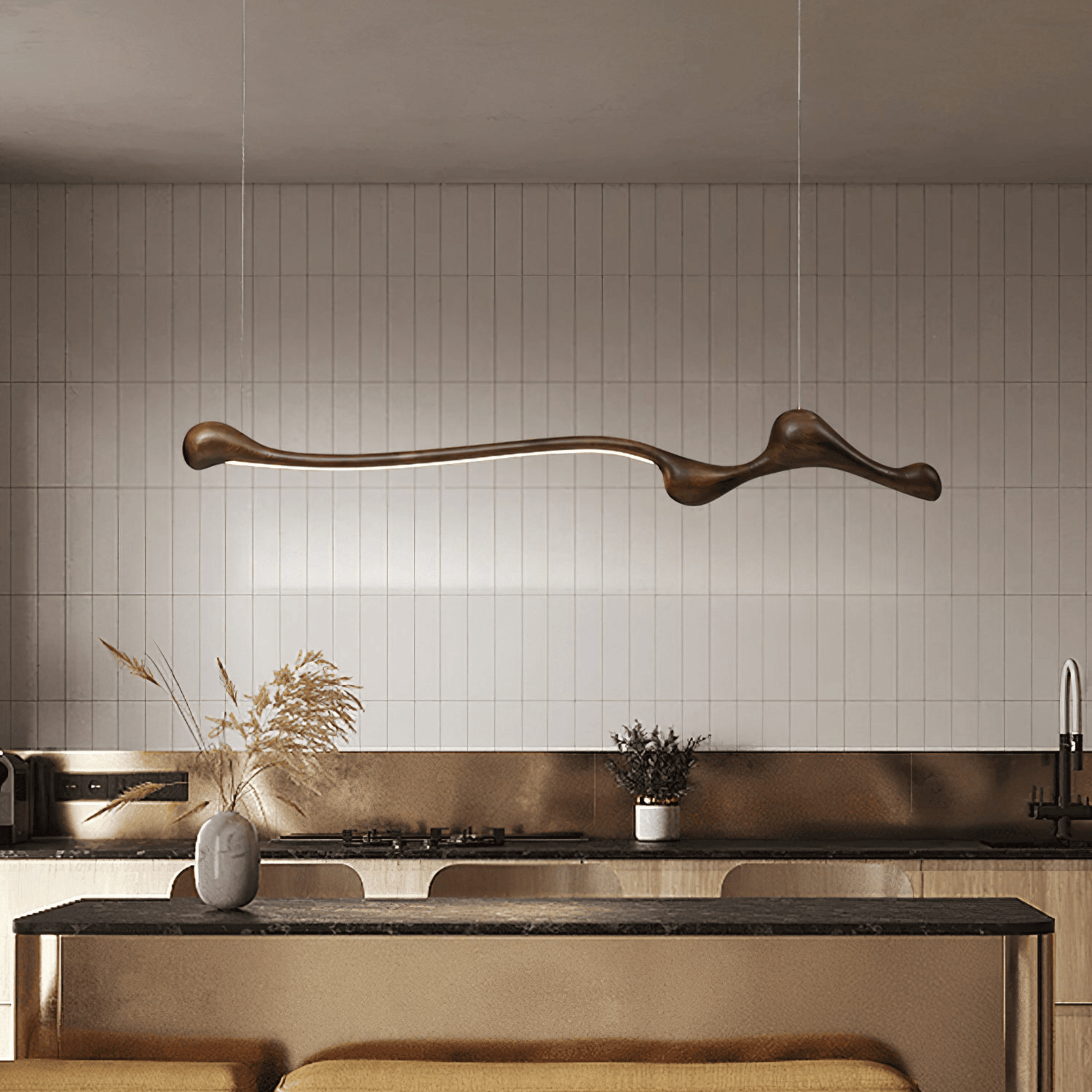 Modern kitchen with a long, curved pendant light fixture.