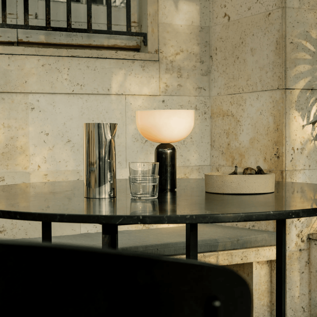 Table with decorative items against a stone wall