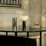 Table with decorative items against a stone wall