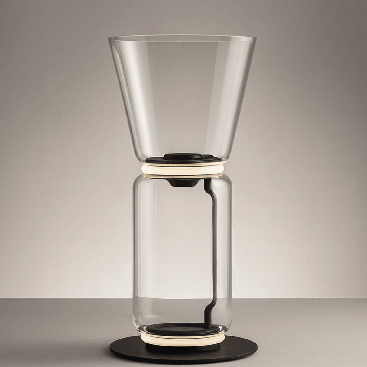 Clear glass coffee maker on a gray background