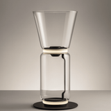 Clear glass coffee maker on a gray background