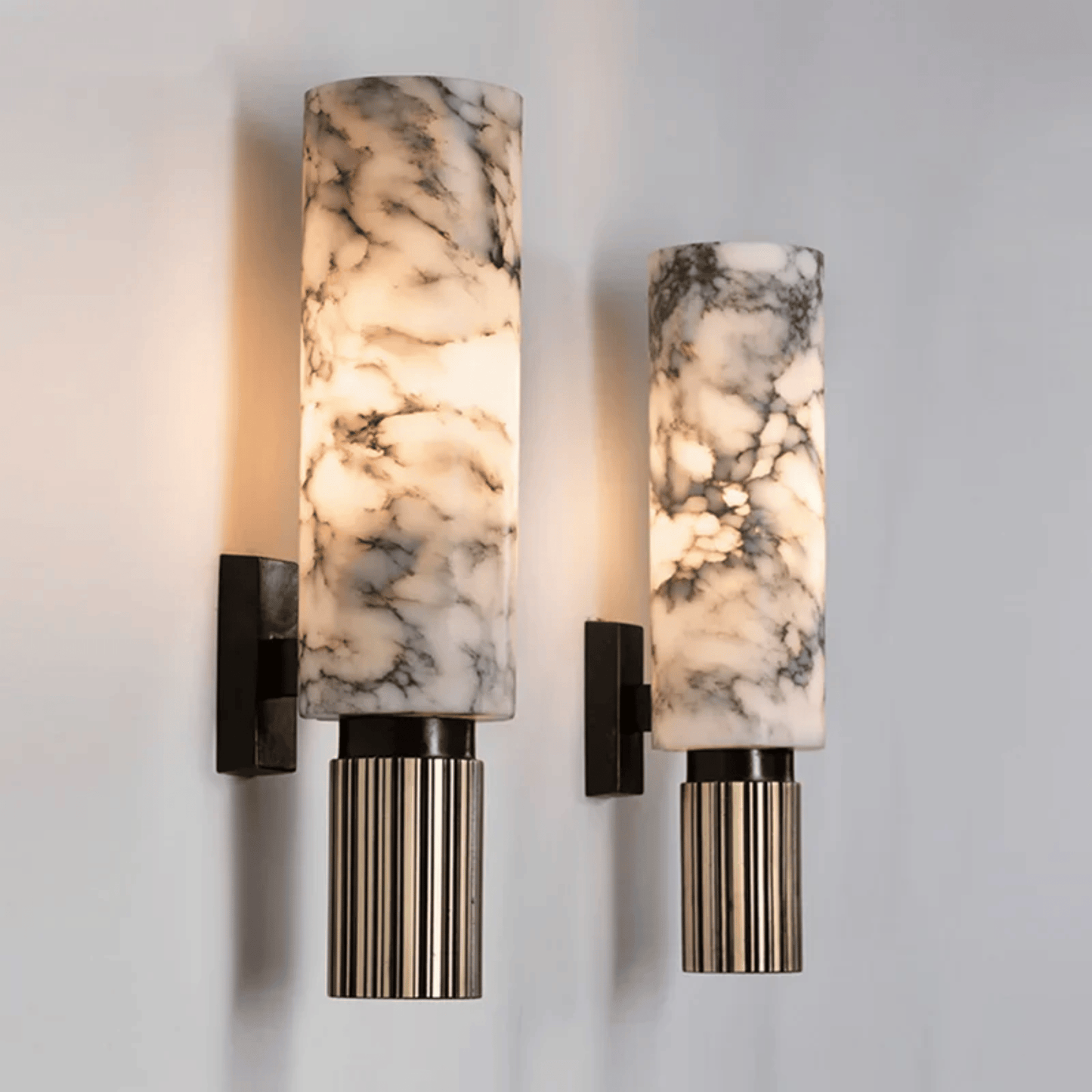 Two marble-patterned wall sconces on a light gray wall.