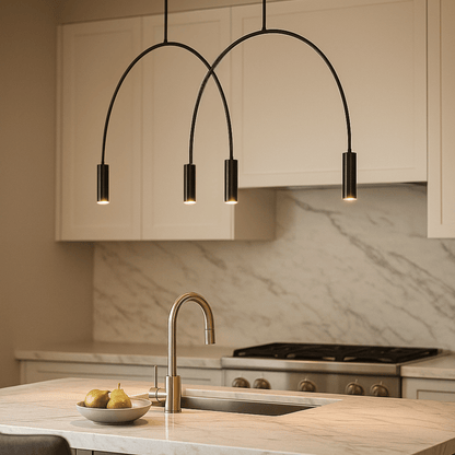 Modern kitchen with a pendant light fixture, marble backsplash, and stainless steel sink.
