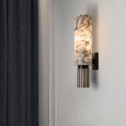 Wall-mounted light fixture with marble-like design on a neutral wall.