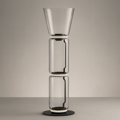 Stack of three transparent glass vases on a neutral background