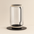 Modern glass table lamp with black base and accents on a beige background