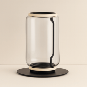 Modern glass table lamp with black base and accents on a beige background