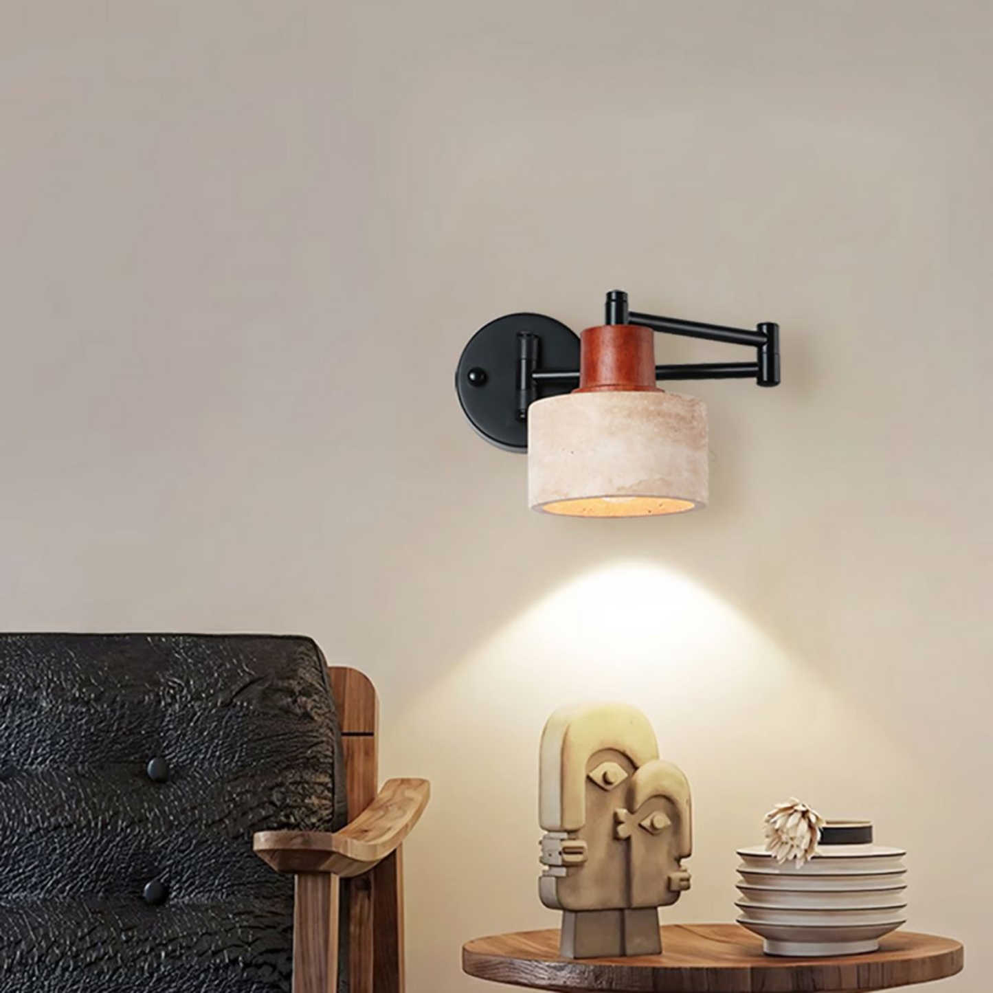 Wall-mounted lamp with a wooden base and decorative sculpture on a table.