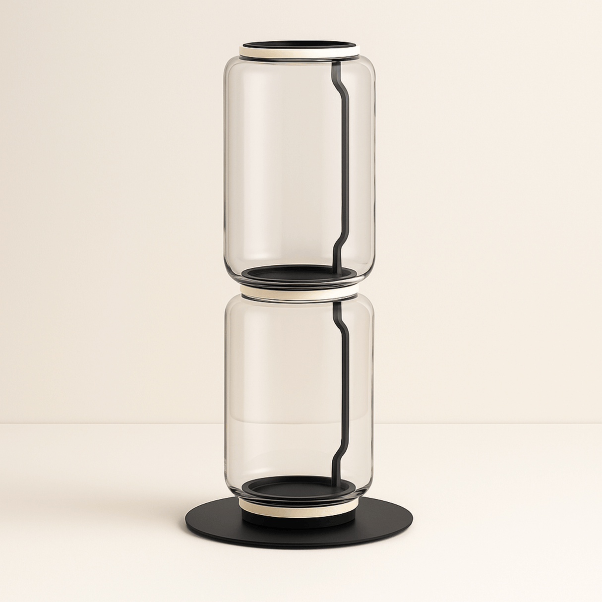 Clear glass vase with black accents on a beige background