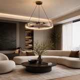 Modern living room with a beige sectional sofa, round coffee table, and decorative elements.