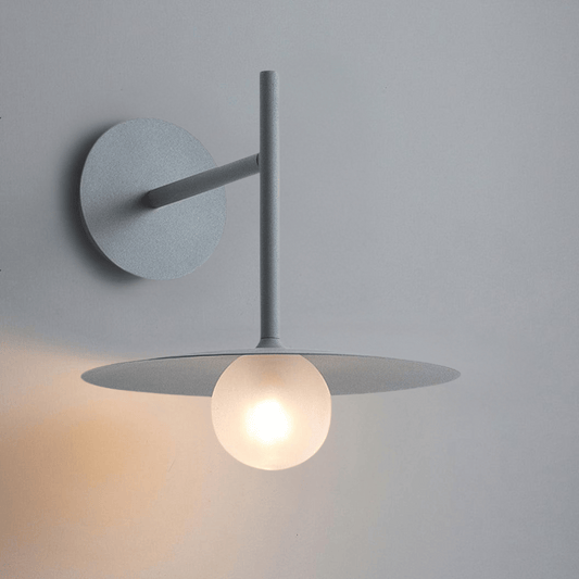 Modern wall-mounted light fixture with a round design on a gray background