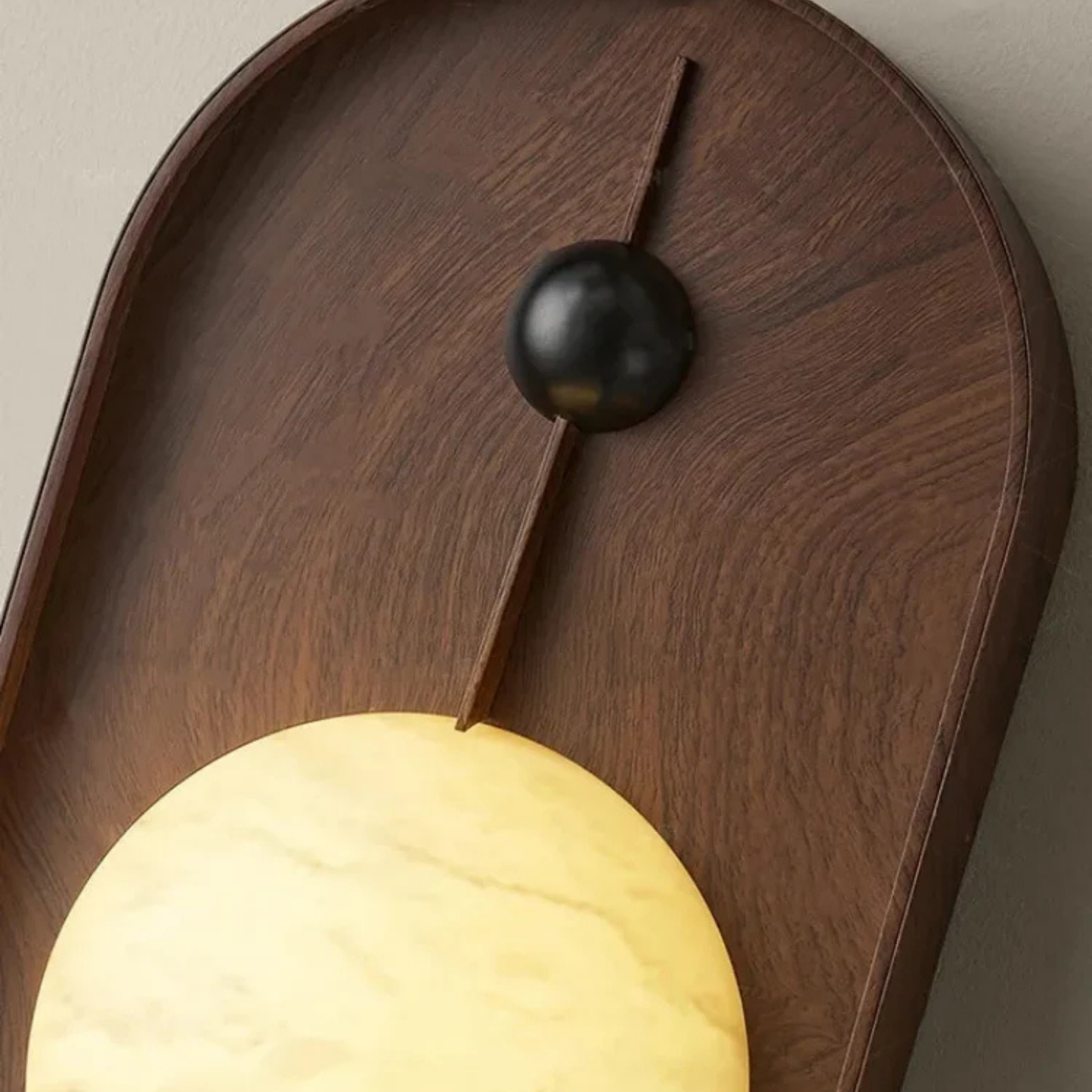 Detailed close-up of the top section of the wooden wall lamp showing black accent knob.