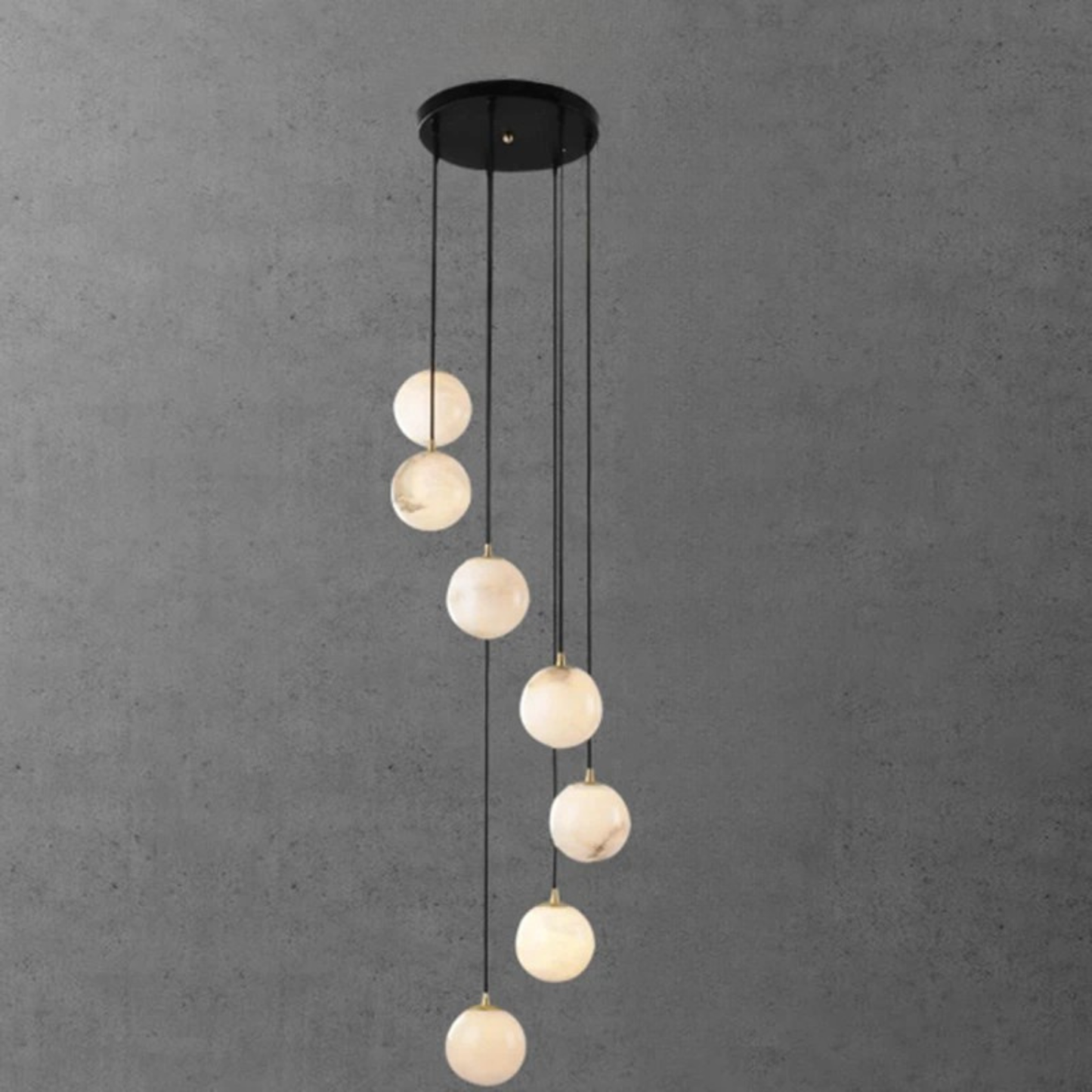 A smaller set of white globe pendant lights in a staggered vertical line against a gray background.
