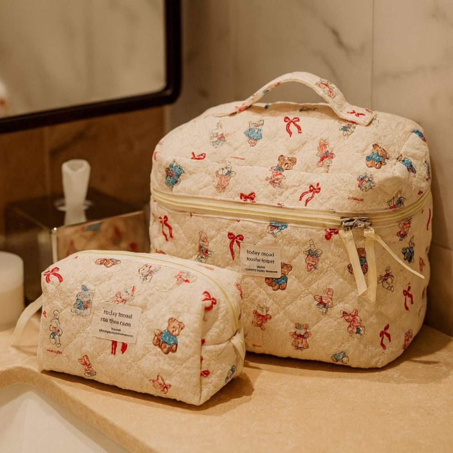 Two patterned toiletry bags on a bathroom counter