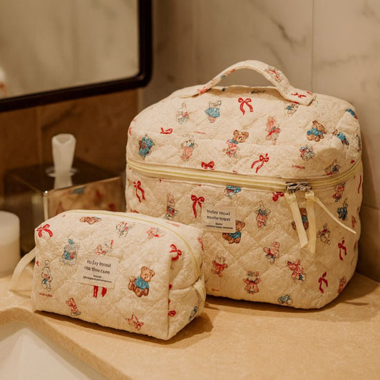 Two patterned toiletry bags on a bathroom counter