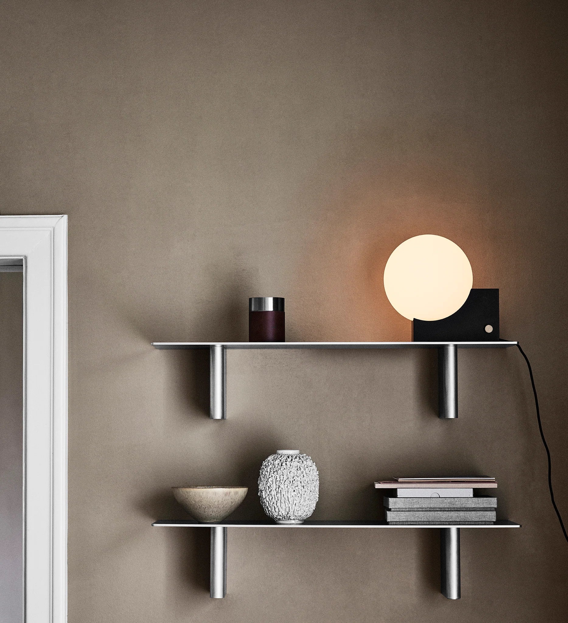 Shelves with decorative items against a brown wall