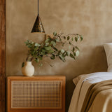 Nursery room with wooden crib, greenery, and soft lighting