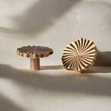 Solid brass cabinet knobs with  on a beige background