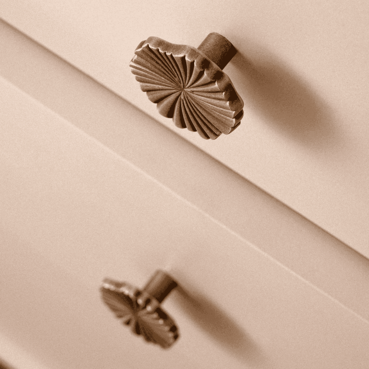 Decorative bronze knobs on a beige surface
