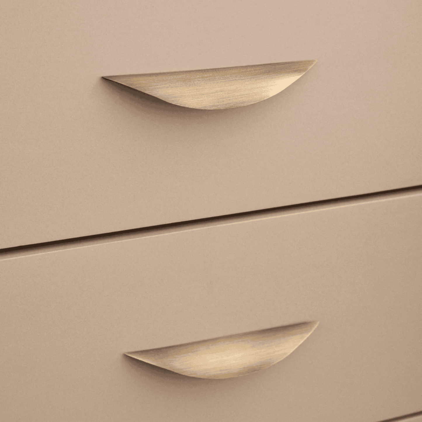 Beige drawers with gold handles on a beige background