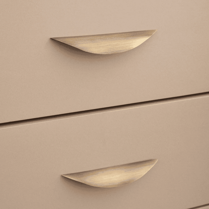 Beige drawers with gold handles on a beige background