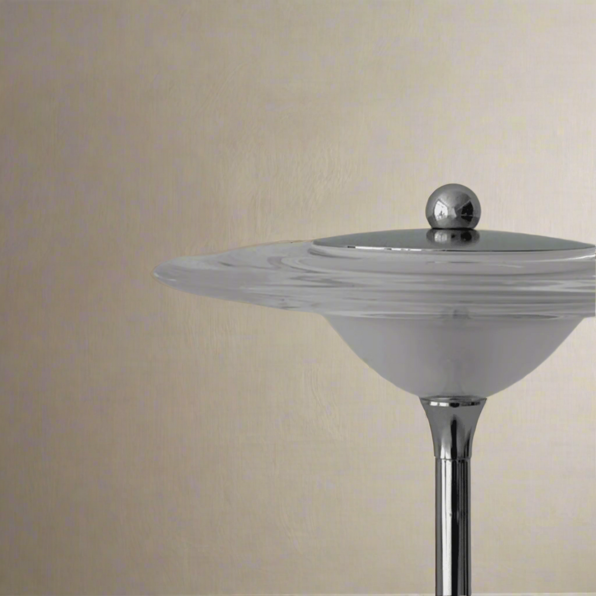 Cylindrical object with a metallic top on a gray background