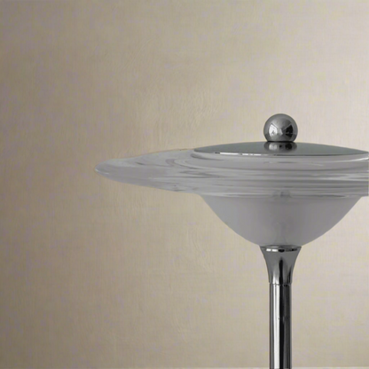 Cylindrical object with a metallic top on a gray background