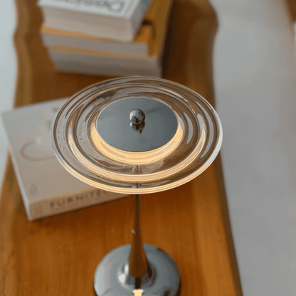 Close-up of a decorative item on a wooden surface with books in the background