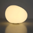 Round, glowing light fixture on a dark background