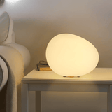 Round table lamp on a side table with a soft glow
