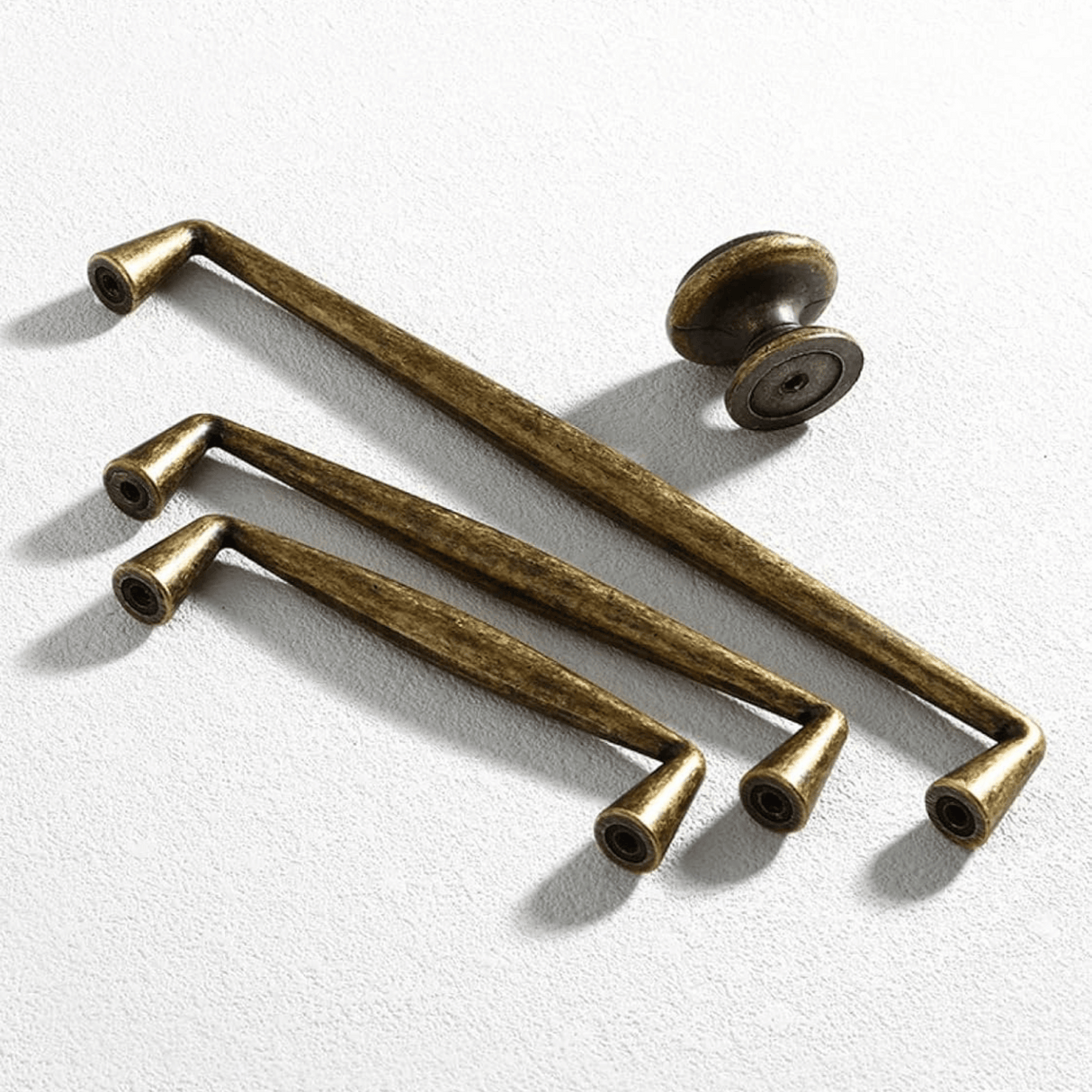 Set of bronze cabinet handles on a white background