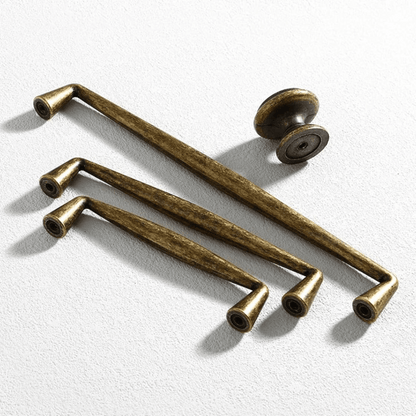 Set of bronze cabinet handles on a white background