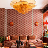 Living room with patterned wallpaper, floral chandelier, and decorative items.
