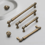 Set of bronze cabinet handles and knobs on a light gray background