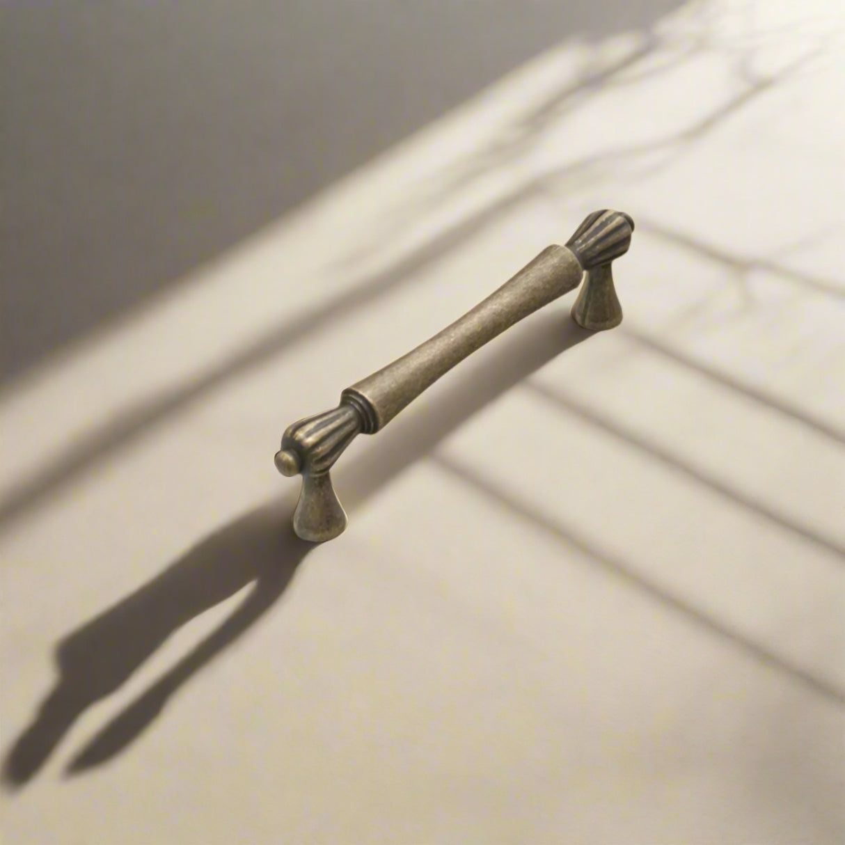 Bronze cabinet handle with dimensions labeled on a white background