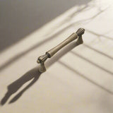 Bronze cabinet handle with dimensions labeled on a white background