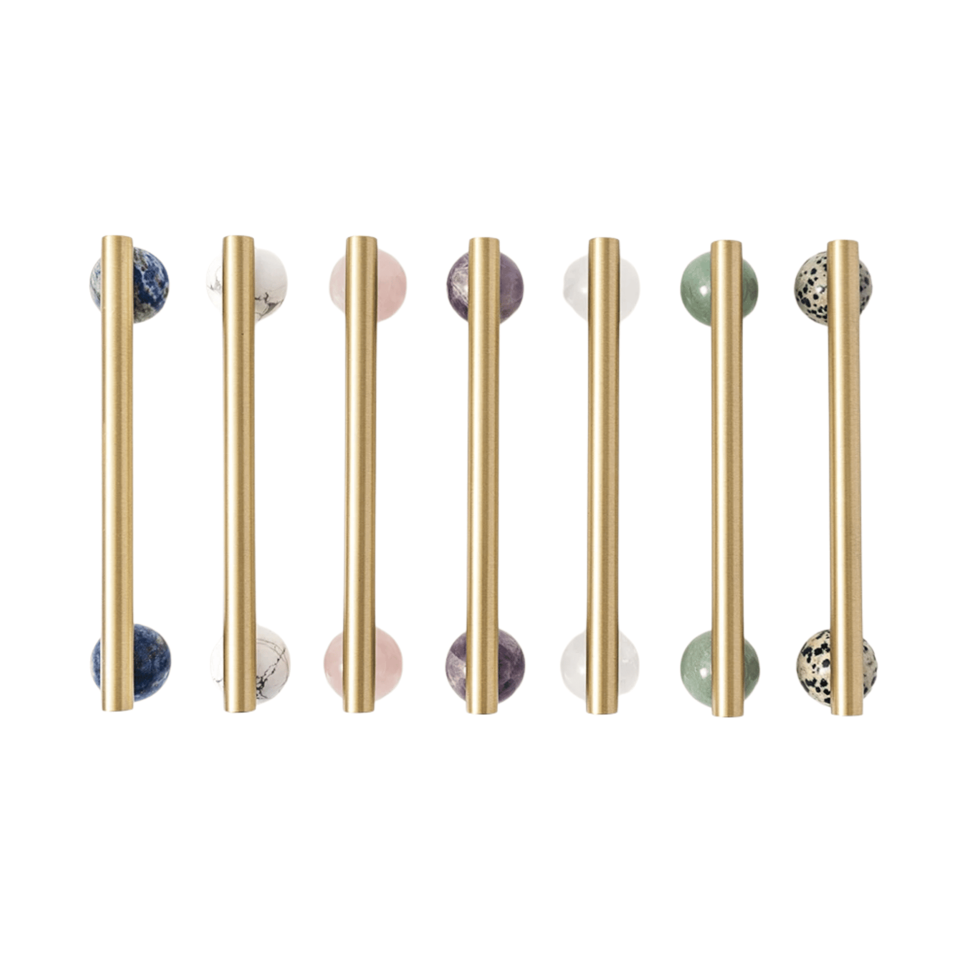 Set of gold cabinet handles with marble knobs on a white background