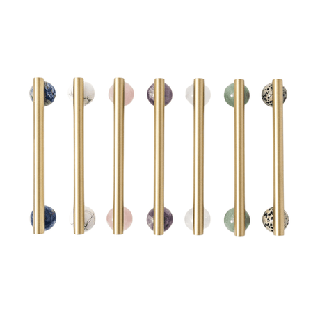 Set of gold cabinet handles with marble knobs on a white background