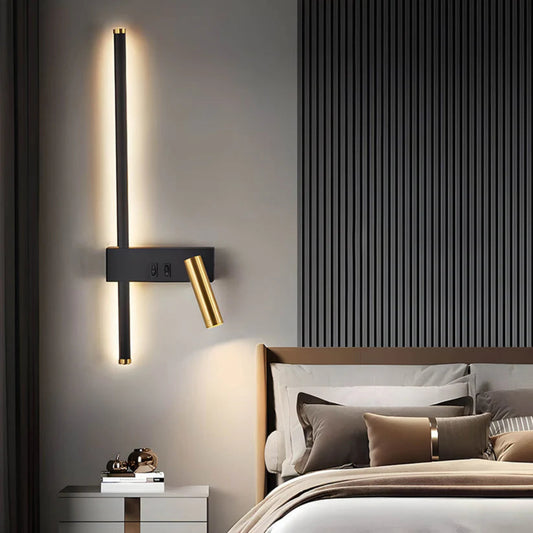 Modern wall sconce in a bedroom setting with a bed and striped wall.
