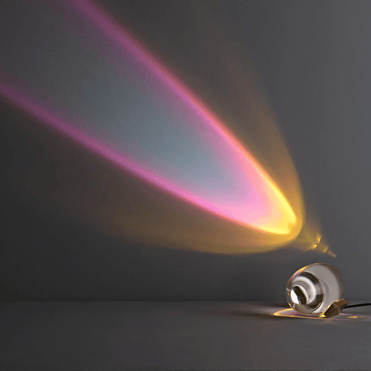 Light bulb emitting colorful rays on a dark background