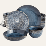 Set of blue ceramic dinnerware with textured design on a white background