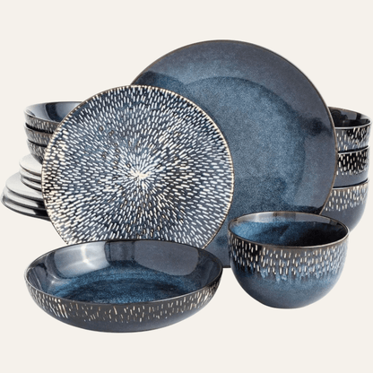 Set of blue ceramic dinnerware with textured design on a white background