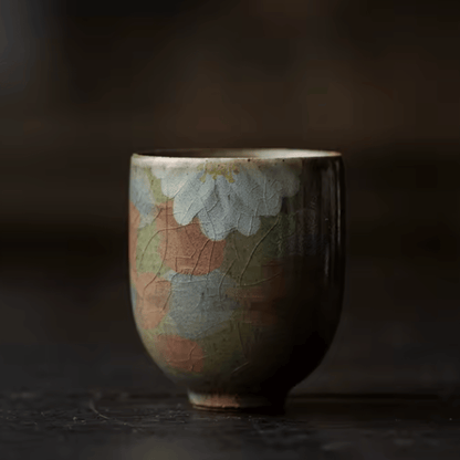 Ceramic cup with floral design on a dark background