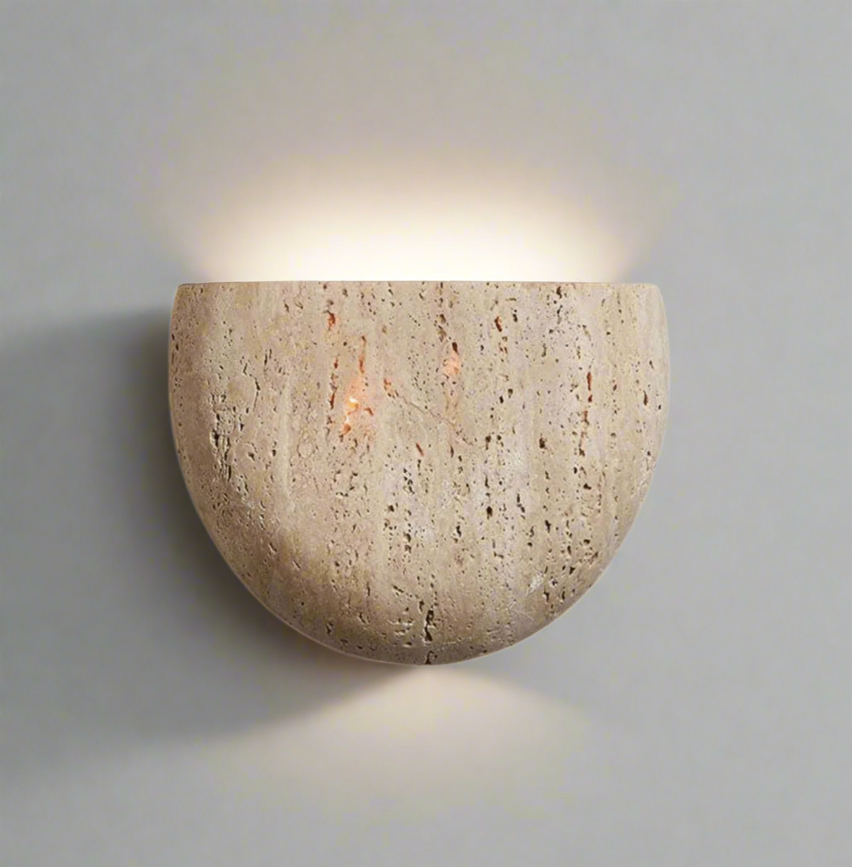 Natural stone wall sconce in beige finish on white background